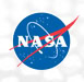 The image shows the NASA logo, featuring a blue circle with white stars, a red chevron, and an orbiting spacecraft path, with the white letters “NASA” in the center.
